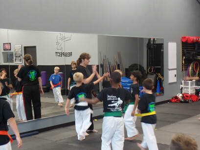 Karate instructor high fives students