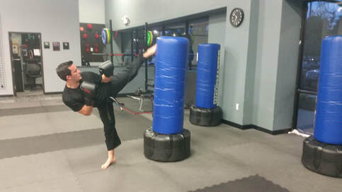 kickboxing student practices a kick